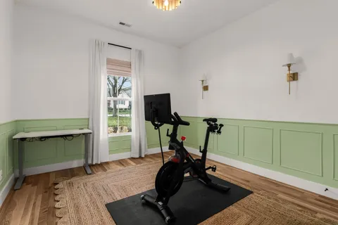 a room with gym equipment and windows