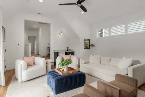 a living room with furniture and a potted plant