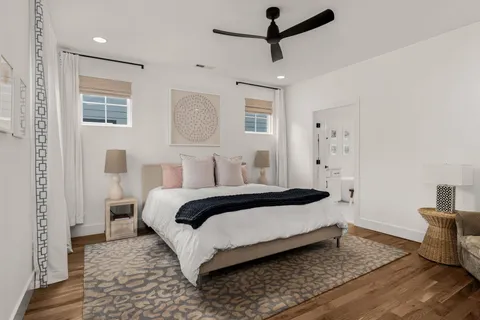 a bedroom with a bed and wooden floor