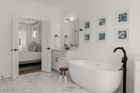 a bathroom with a tub sink and mirror