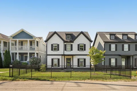a view of a brick building next to a yard