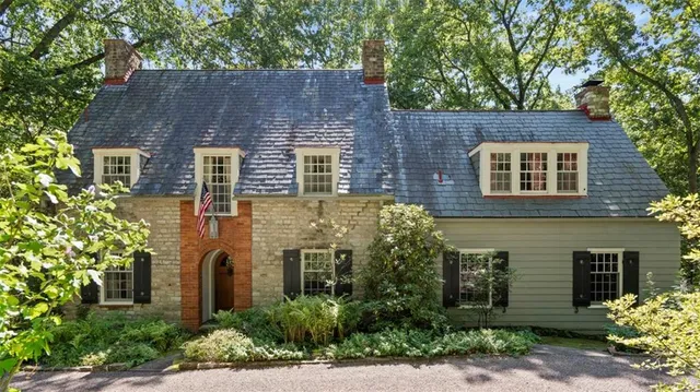 front view of house with a yard and plants
