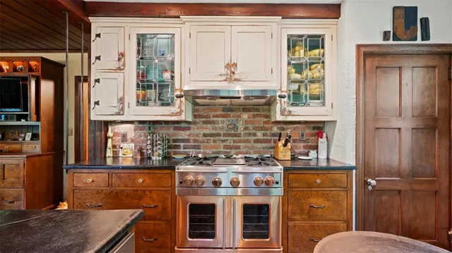 a bathroom with a granite countertop sink a toilet and shower