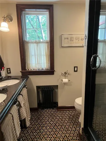 a bedroom with a bed dresser and a window