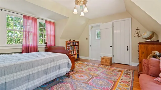 a bedroom with furniture and wooden floor