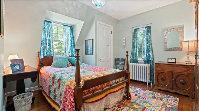 a bedroom with a bed and a mirror