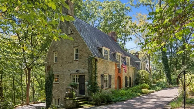 a view of a large brick building next to a tree