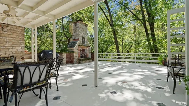 a large yard with lots of green space and house in the back