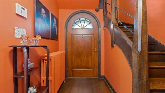 a view of hallway with stairs and wooden floor
