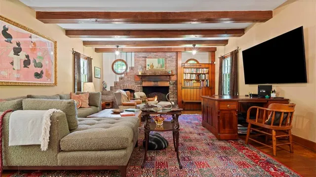 a living room with fireplace furniture and a flat screen tv