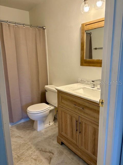 1550 South Belcher Road, Unit 211 Clearwater, FL 33764 - Photo 13 of 26 a bathroom with a sink a toilet and shower