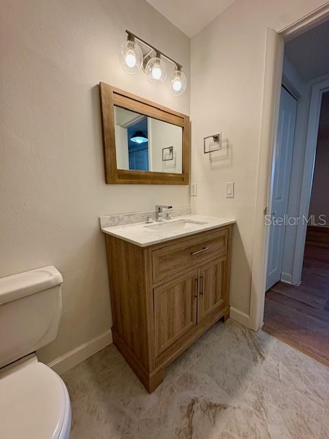 1550 South Belcher Road, Unit 211 Clearwater, FL 33764 - Photo 14 of 26 a bathroom with a toilet sink and mirror