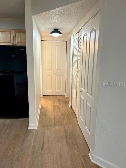 1550 South Belcher Road, Unit 211 Clearwater, FL 33764 - Photo 17 of 26 a view of a hallway with wooden floor and staircase