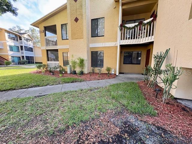 1550 South Belcher Road, Unit 211 Clearwater, FL 33764 - Photo 20 of 26 a front view of a house with a yard fire pit and outdoor seating
