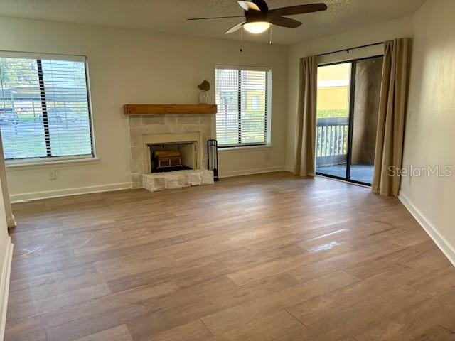 1550 South Belcher Road, Unit 211 Clearwater, FL 33764 - Photo 2 of 26 an empty room with windows and a fireplace