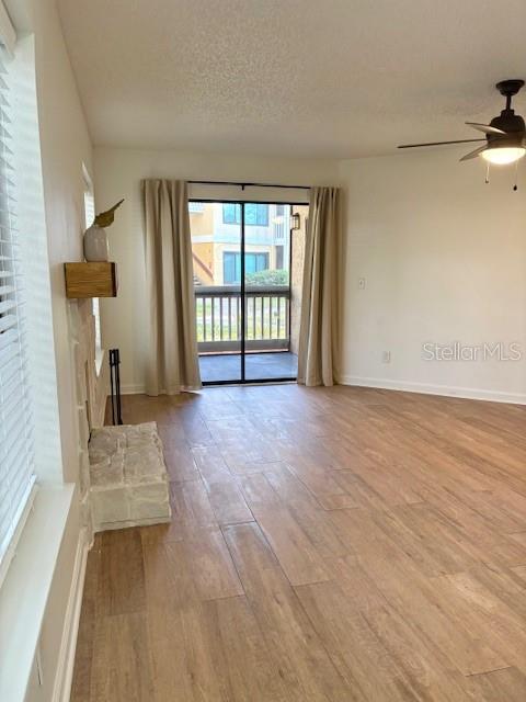 1550 South Belcher Road, Unit 211 Clearwater, FL 33764 - Photo 4 of 26 a view of empty room with wooden floor and fan