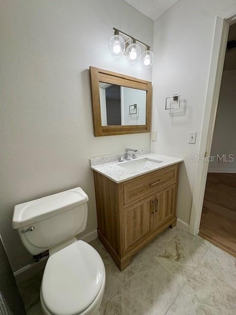 1550 South Belcher Road, Unit 211 Clearwater, FL 33764 - Photo 9 of 26 a bathroom with a toilet sink and mirror