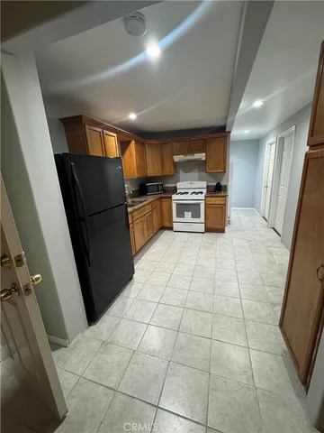 a kitchen with stainless steel appliances a refrigerator and a stove top oven