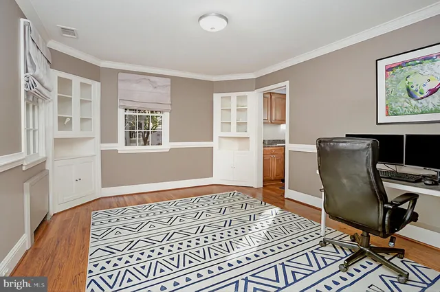 a view of room with wooden floor and furniture