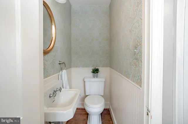 a white toilet sitting next to a bathroom sink