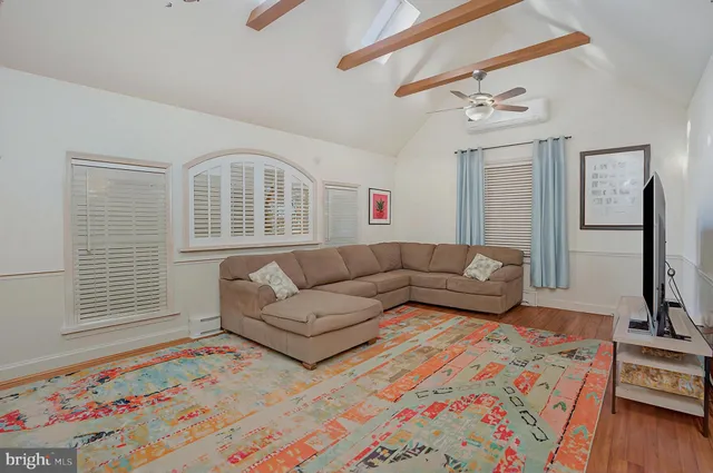 a bedroom with furniture and a flat screen tv