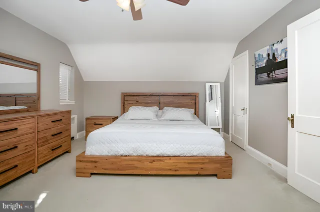 a bedroom with a bed and closet with mirror