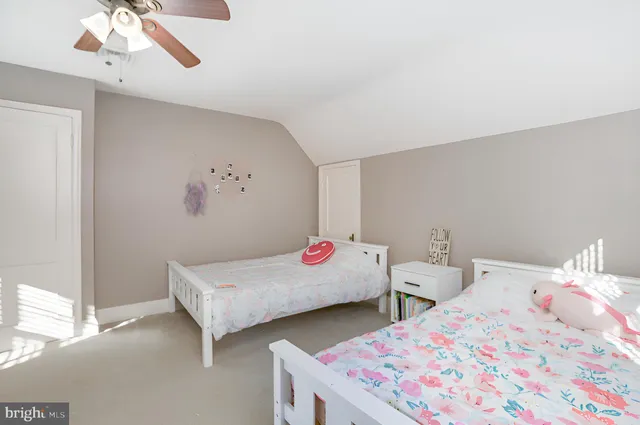 a bedroom with two beds and painted walls