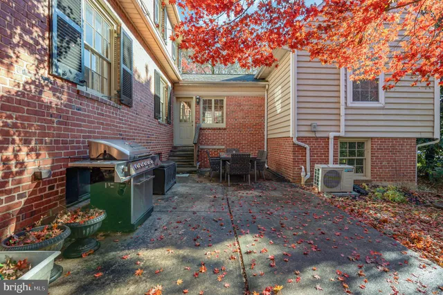 a view of a backyard with chairs and a fire pit
