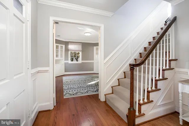 a view of entryway and hall with wooden floor