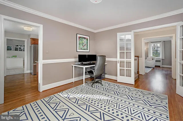 a workspace with wooden floor and a rug