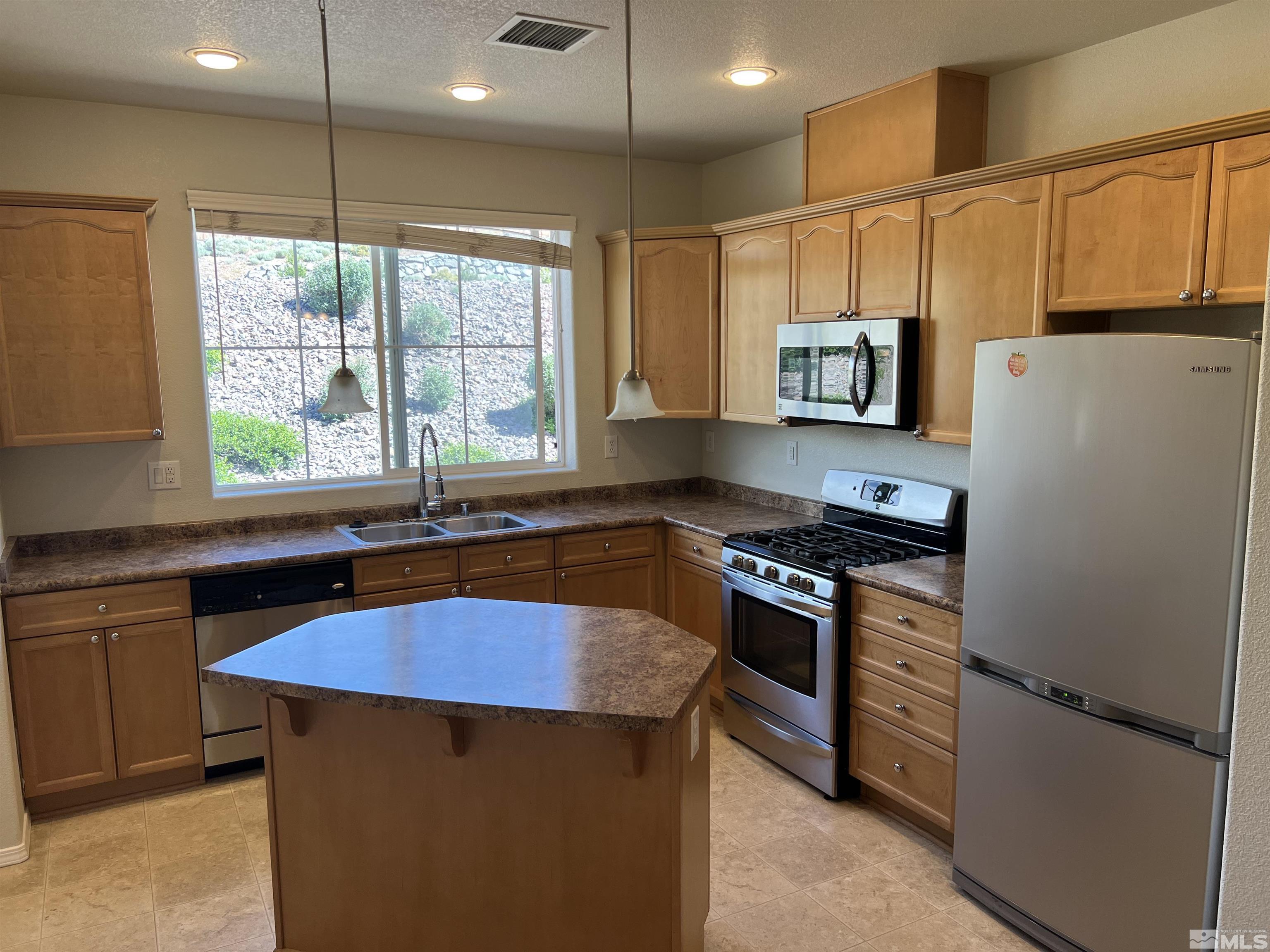 3078 Sterling Ridge Circle Sparks, NV 89431 - Photo 1 of 16 a kitchen with stainless steel appliances granite countertop a sink stove and refrigerator