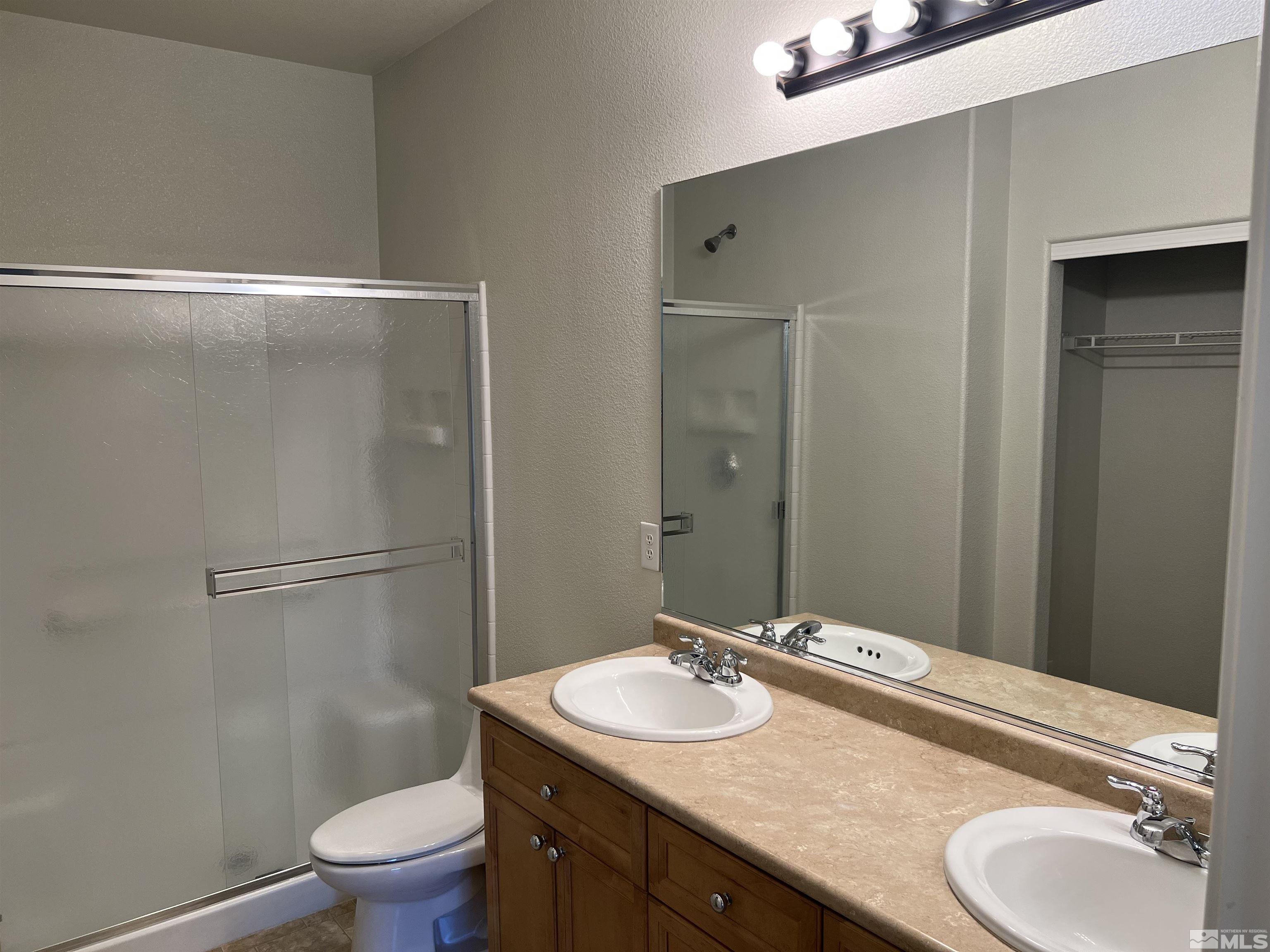 3078 Sterling Ridge Circle Sparks, NV 89431 - Photo 11 of 16 a bathroom with a sink toilet and shower