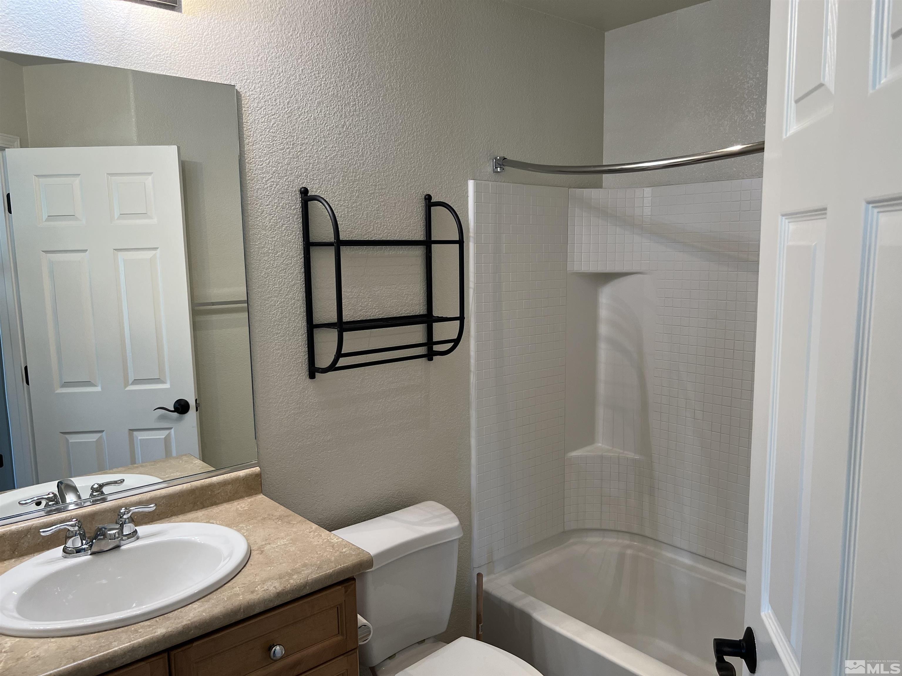 3078 Sterling Ridge Circle Sparks, NV 89431 - Photo 15 of 16 a bathroom with a sink toilet and shower