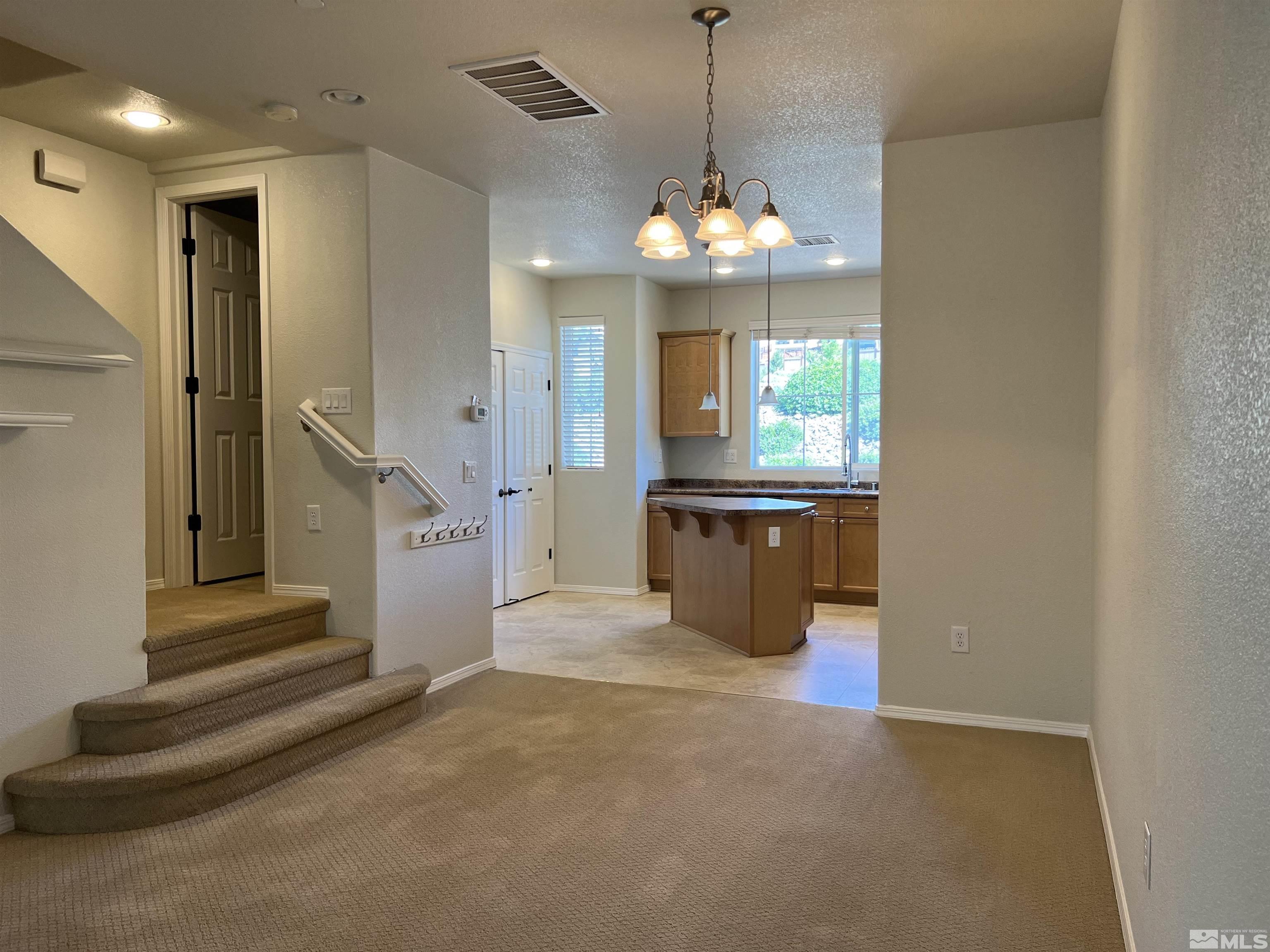 3078 Sterling Ridge Circle Sparks, NV 89431 - Photo 3 of 16 a view of a kitchen with a sink and a chandelier