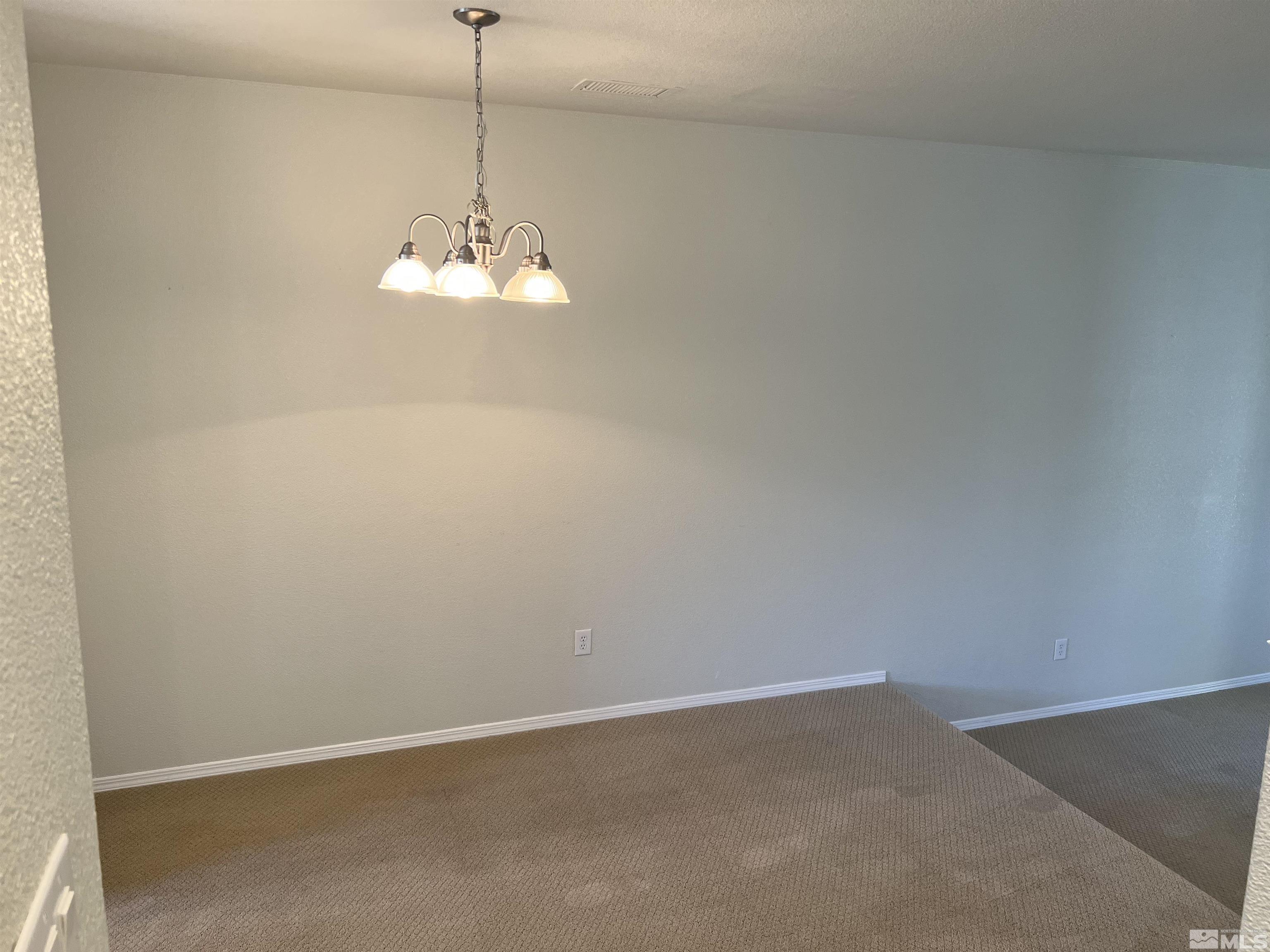 3078 Sterling Ridge Circle Sparks, NV 89431 - Photo 8 of 16 a room with a chandelier fan and a window