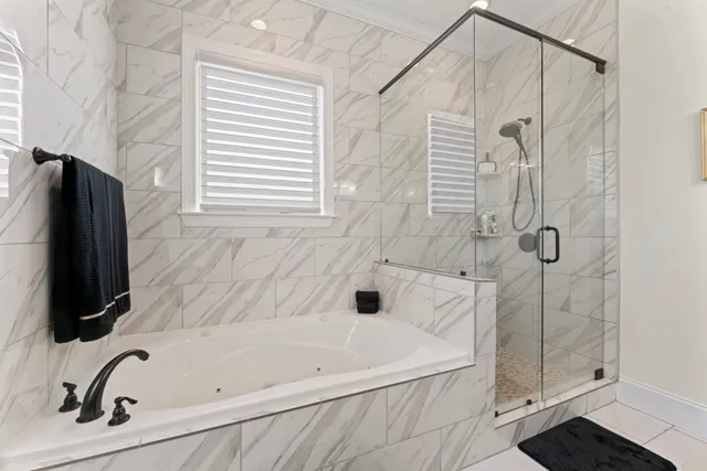 a bathroom with a toilet a sink a mirror and a window