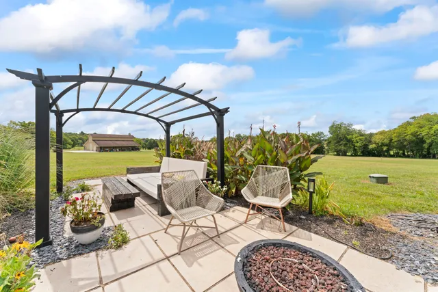 a view of a house with a yard and road