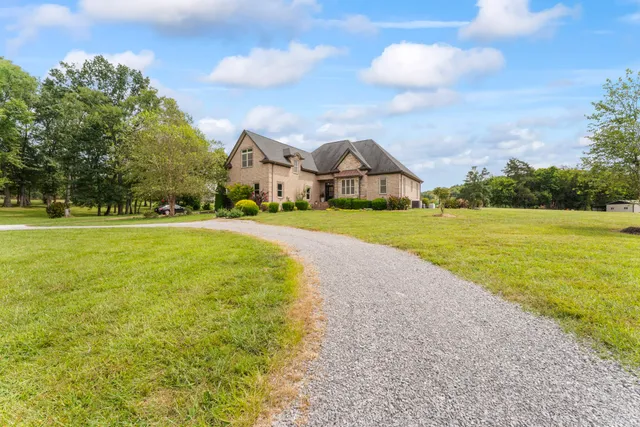 a front view of house with yard and green space