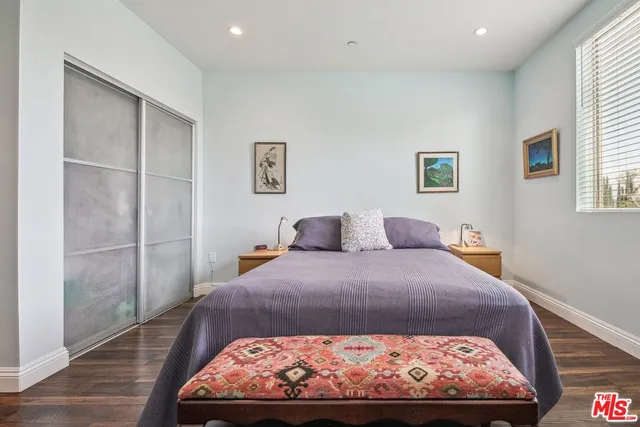 a large bed sitting in a bedroom next to a window