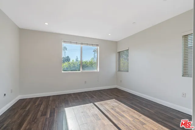 a view of wooden floor and windows in a room