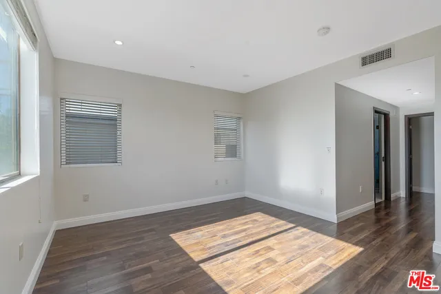 a view of a room with wooden floor