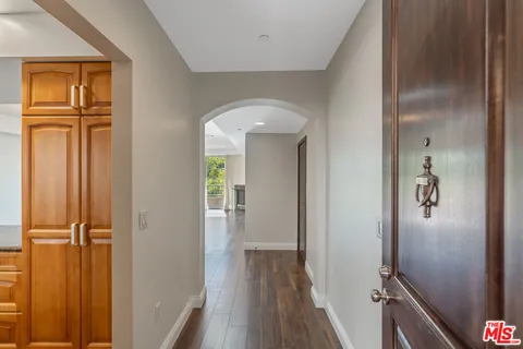 a kitchen with kitchen island granite countertop a stove top oven sink and cabinets