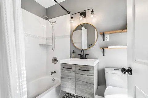 a bathroom with a sink toilet and shower
