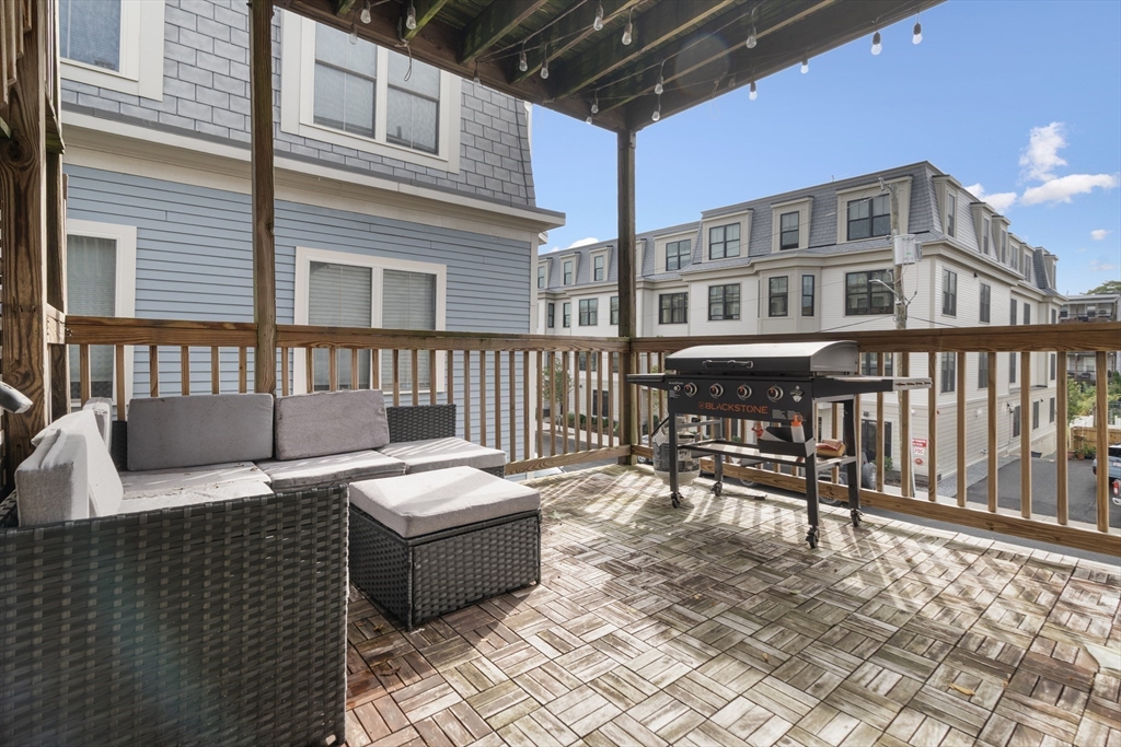 52 O Street, Unit 3 Boston, MA 02127 - Photo 16 of 20 a roof deck with a couch and chairs