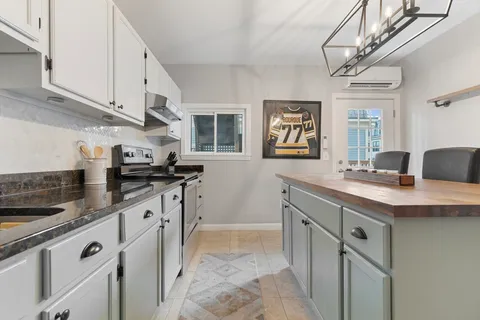 a kitchen with stainless steel appliances granite countertop a sink stove and cabinets