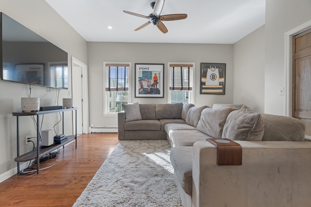 52 O Street, Unit 3 Boston, MA 02127 - Photo 7 of 20 a living room with furniture ceiling fan and a wooden floor