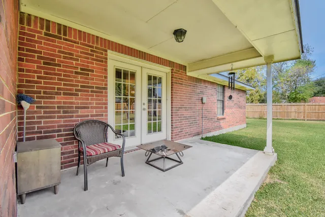 a backyard of a house with yard and outdoor seating