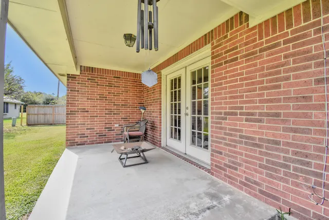 a backyard of a house with table and chairs