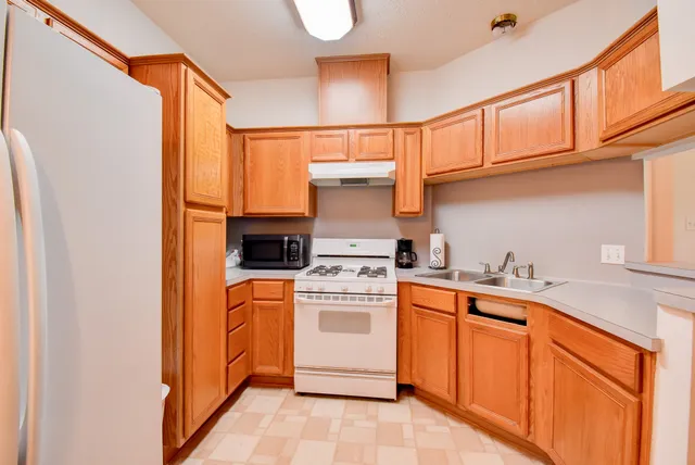 a kitchen with stainless steel appliances granite countertop a stove and a refrigerator