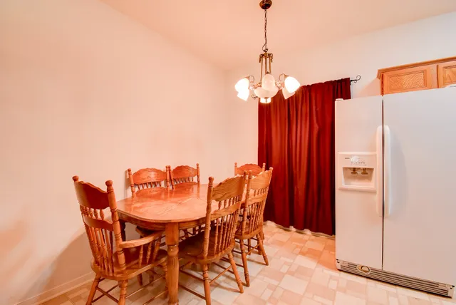 a dining room with furniture and wooden floor